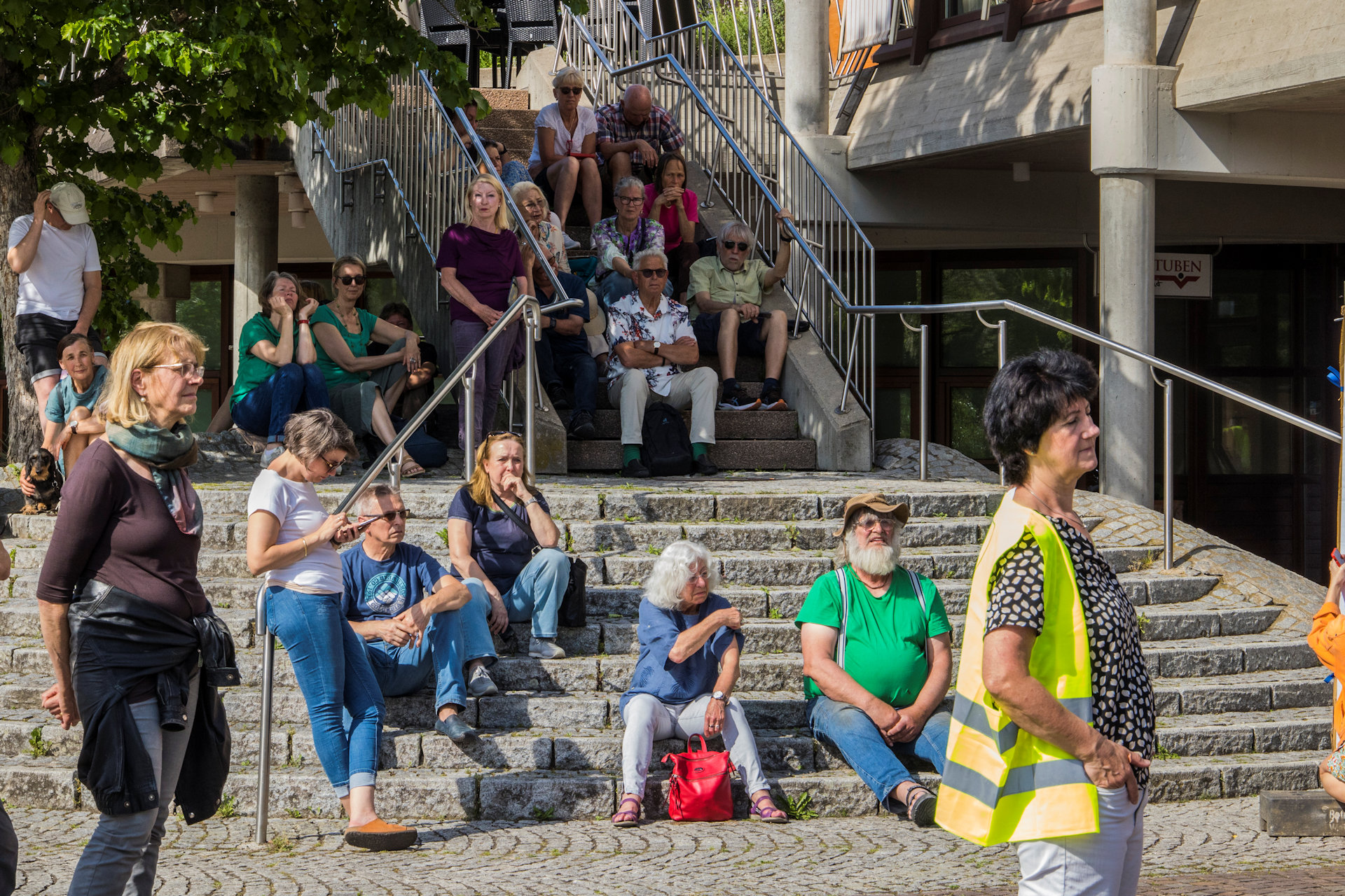 Menschen in einem schatigen Raum und Bündel von Luftballonen